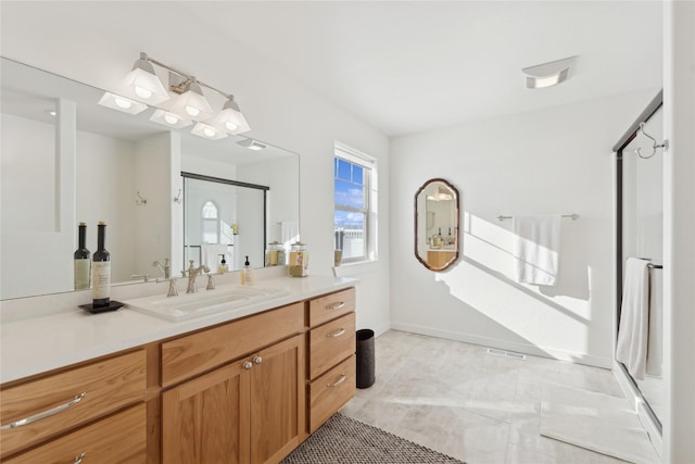 bathroom featuring tile patterned floors, vanity, and baseboards