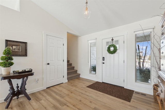 211 Mcwenneger Dr, Kalispell, MT 59901 - entryway featuring vaulted ceiling, light wood-type flooring, and stairs