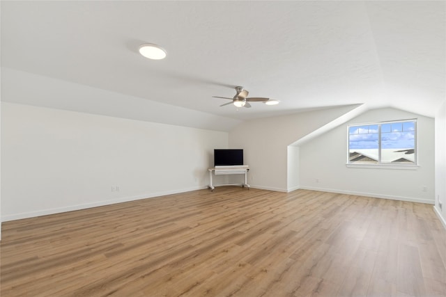 bonus room featuring vaulted ceiling, light wood-style flooring, and baseboards