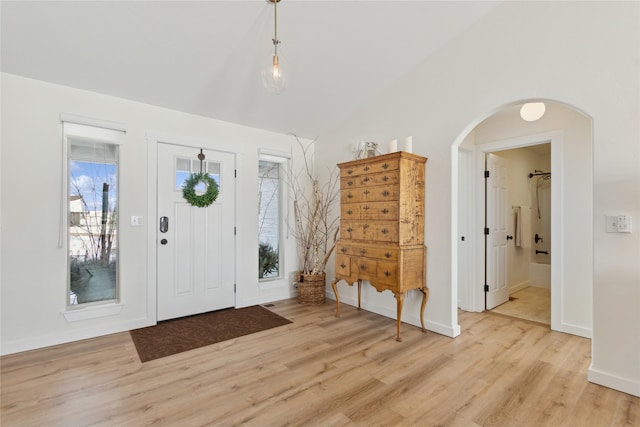 211 Mcwenneger Dr, Kalispell, MT 59901 - entryway featuring vaulted ceiling, light wood-type flooring, and arched walkways