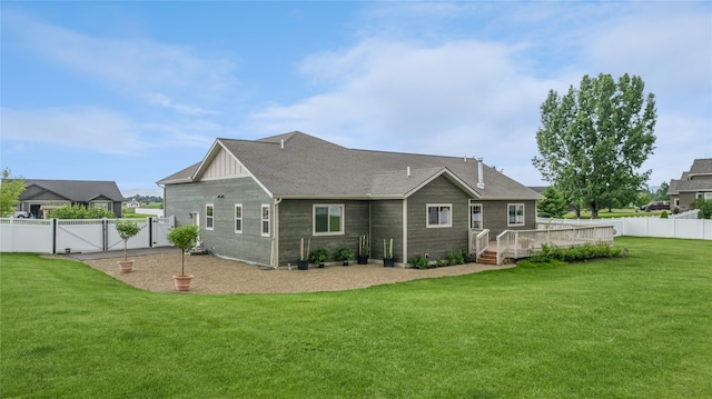 back of property with a gate, fence, board and batten siding, and a yard