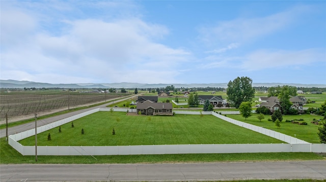 view of home's community with a residential view, a mountain view, and fence