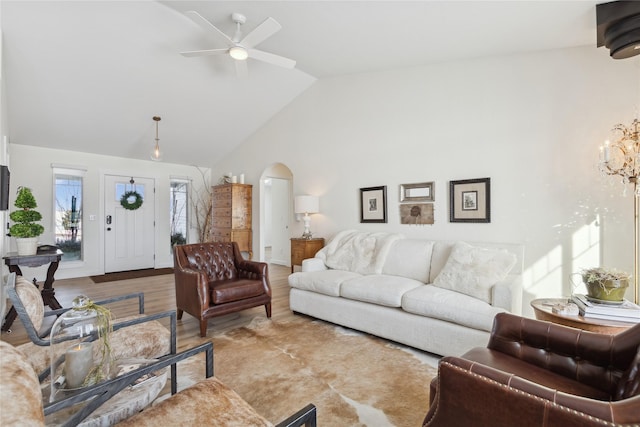 211 Mcwenneger Dr, Kalispell, MT 59901 - living area featuring wood finished floors, ceiling fan, a chandelier, high vaulted ceiling, and arched walkways