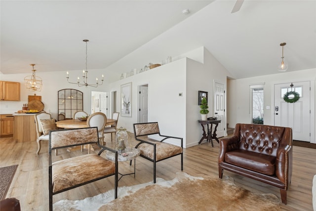 211 Mcwenneger Dr, Kalispell, MT 59901 - living room featuring light wood-style flooring, a chandelier, and high vaulted ceiling