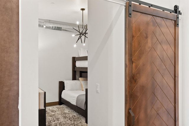 interior space with a barn door and a notable chandelier