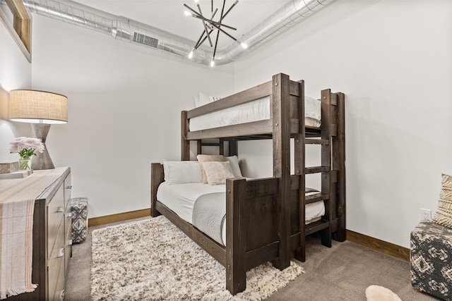 bedroom with carpet floors and an inviting chandelier