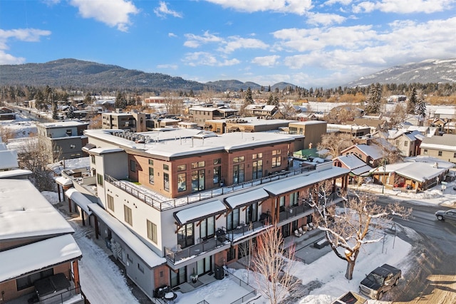 snowy aerial view with a mountain view