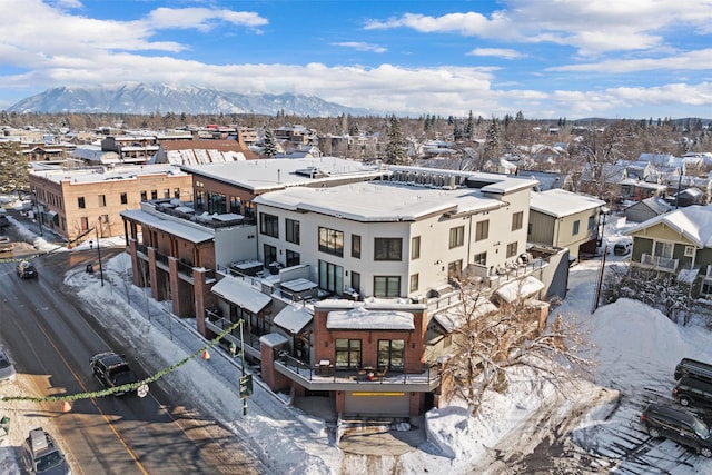 snowy aerial view featuring a mountain view