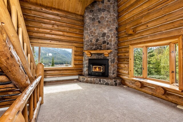 21 Barnes Ln, Noxon, MT 59853 - unfurnished living room featuring a baseboard heating unit, wooden ceiling, high vaulted ceiling, log walls, and carpet floors