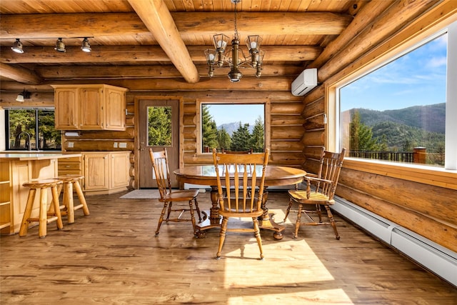 21 Barnes Ln, Noxon, MT 59853 - dining area with a mountain view, wood ceiling, a wall mounted air conditioner, and baseboard heating