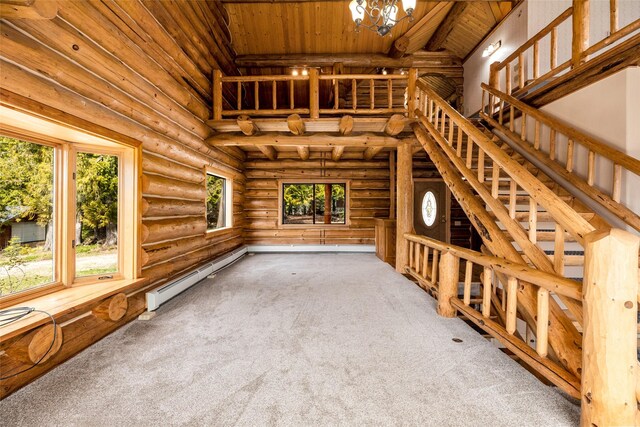 21 Barnes Ln, Noxon, MT 59853 - unfurnished living room with wooden ceiling, carpet, high vaulted ceiling, log walls, and baseboard heating