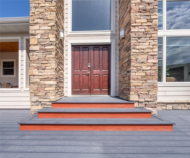 entrance to property featuring stone siding