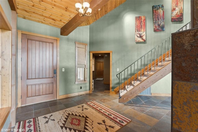 290 Wilderness Club Dr, Eureka, MT 59917 - entrance foyer featuring stairway, a chandelier, wooden ceiling, beamed ceiling, and baseboards