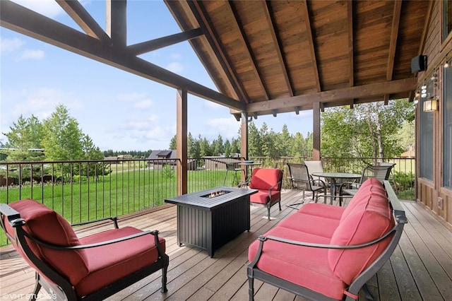 290 Wilderness Club Dr, Eureka, MT 59917 - wooden terrace with outdoor dining space, a lawn, and a fire pit