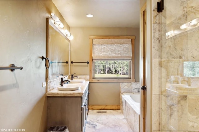 290 Wilderness Club Dr, Eureka, MT 59917 - full bath featuring a garden tub, a sink, visible vents, and double vanity