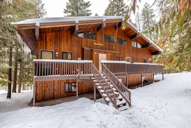 view of snow covered rear of property