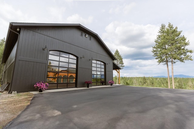 view of side of home featuring an outbuilding