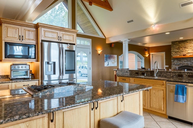 kitchen with visible vents, appliances with stainless steel finishes, dark stone counters, and a sink