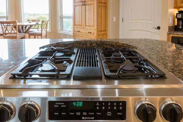 interior details featuring dark stone counters and gas stove