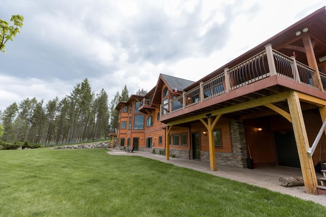 back of house with a yard and a patio