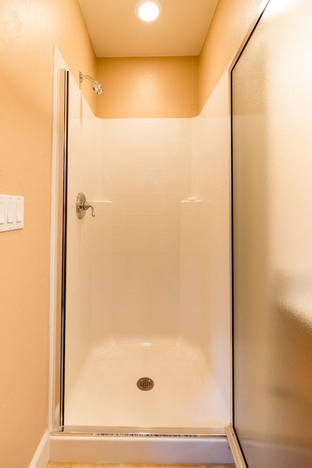 full bathroom featuring a shower stall