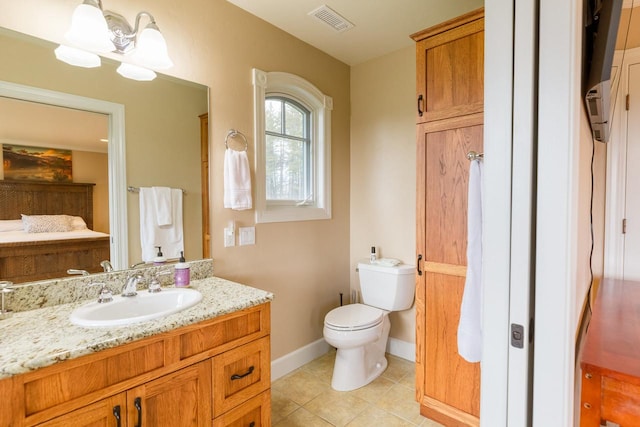 bathroom featuring visible vents, toilet, vanity, tile patterned flooring, and baseboards