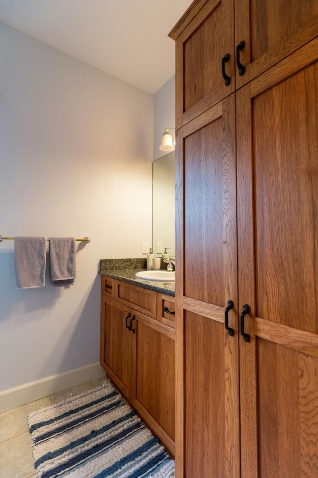 bathroom featuring tile patterned flooring, vanity, and baseboards