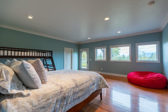 bedroom featuring recessed lighting, baseboards, wood finished floors, and ornamental molding