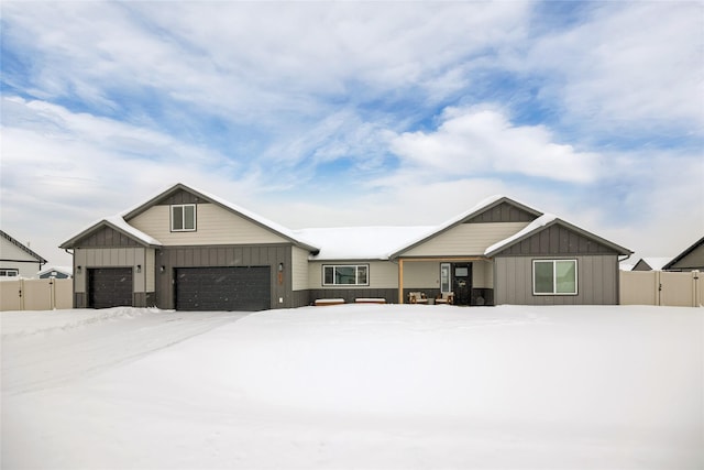 view of front of property with board and batten siding and fence