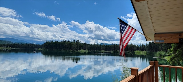 property view of water with a mountain view and a wooded view