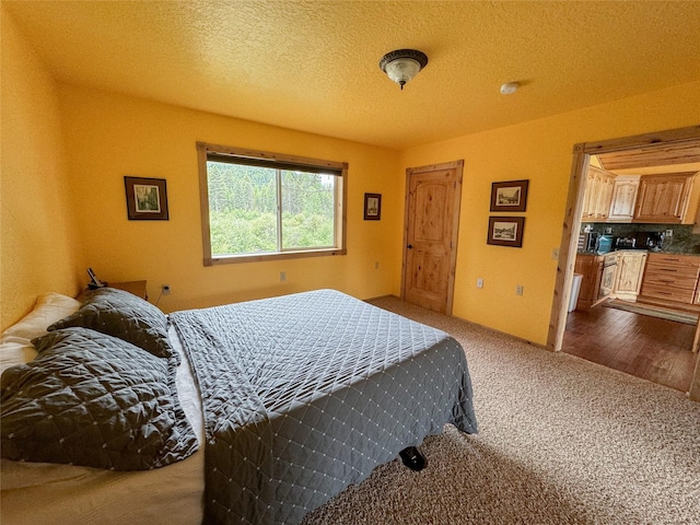 carpeted bedroom with a textured ceiling