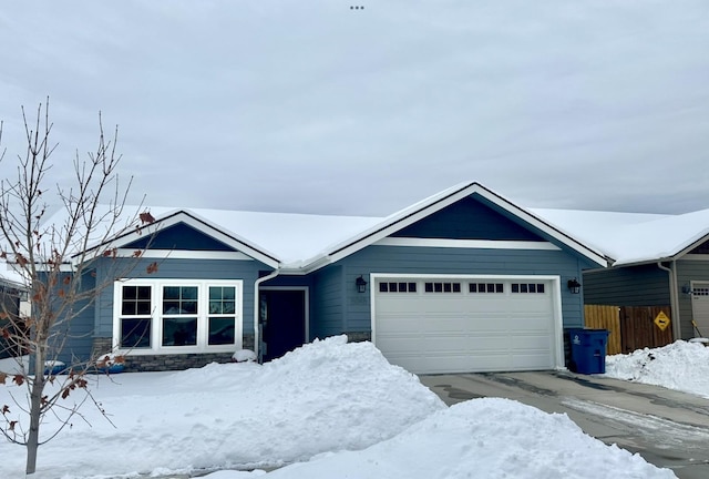 ranch-style home featuring fence, driveway, and an attached garage