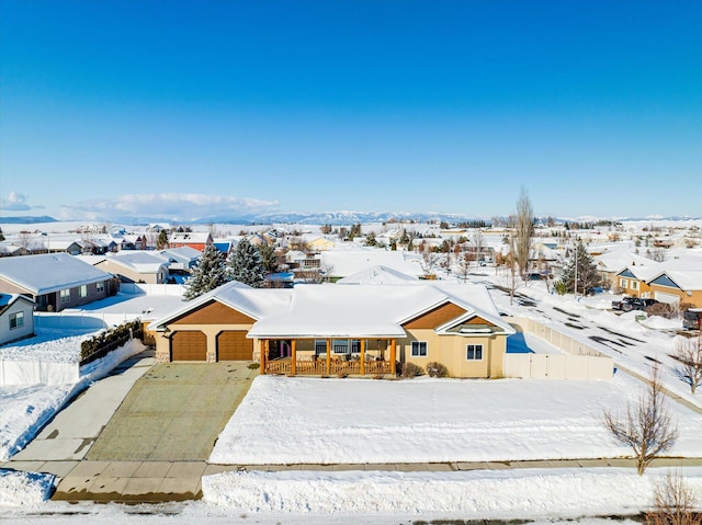 snowy aerial view with a residential view