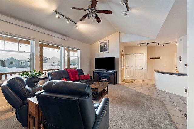 living room with lofted ceiling, rail lighting, a ceiling fan, and light tile patterned flooring