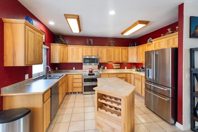 kitchen featuring a sink, light countertops, a kitchen island, and stainless steel appliances