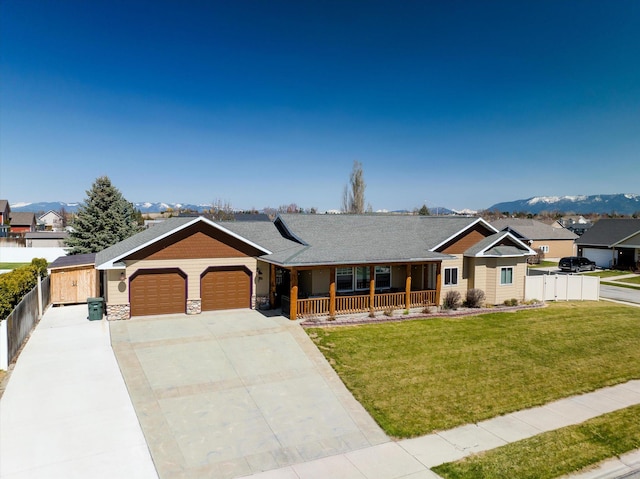 ranch-style house with fence, a garage, a porch, a front yard, and driveway