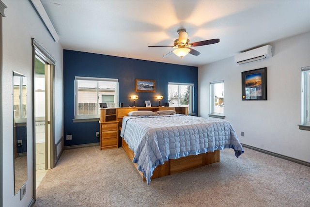 bedroom with baseboards, a wall unit AC, a ceiling fan, and light colored carpet