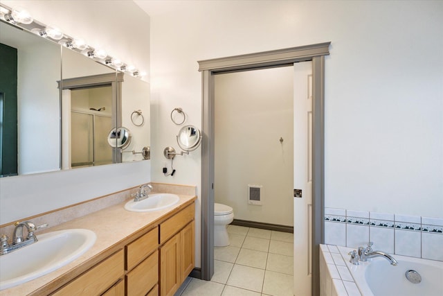 bathroom with tile patterned flooring, a sink, a tub, and toilet