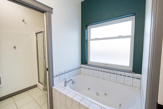 bathroom with baseboards, a stall shower, tile patterned flooring, and a jetted tub