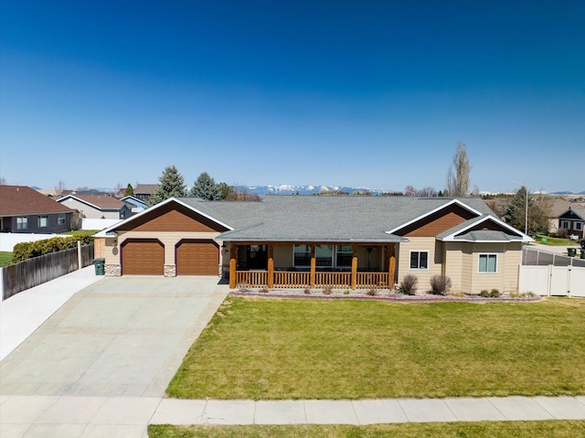 ranch-style home featuring a porch, driveway, a garage, fence, and a front lawn