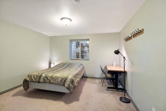 carpeted bedroom featuring baseboards