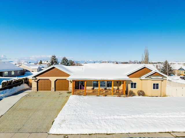 single story home with an attached garage, covered porch, and concrete driveway