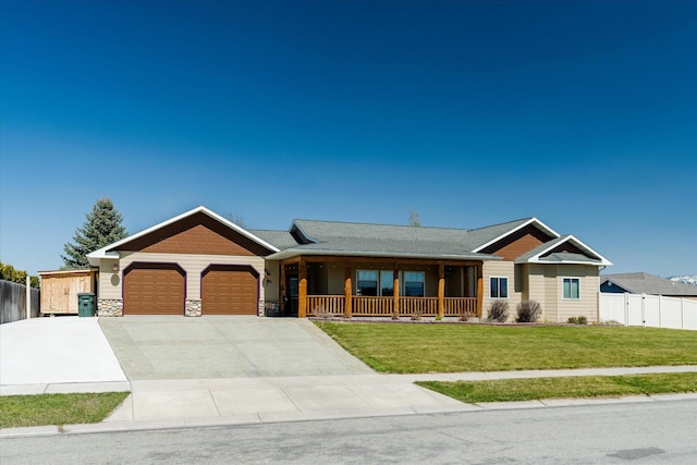 view of front of home with a garage, a front lawn, fence, concrete driveway, and a porch