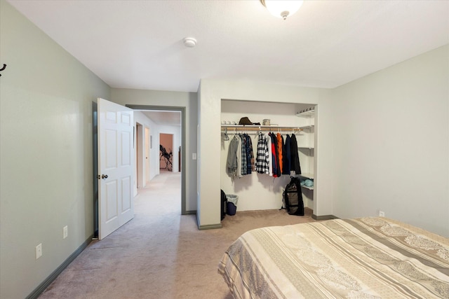 bedroom featuring light carpet and a closet