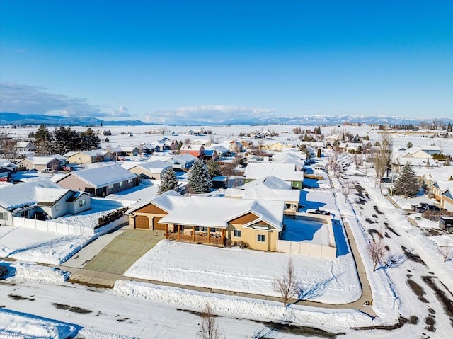 snowy aerial view with a residential view