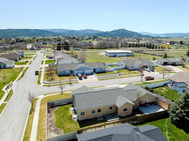 drone / aerial view featuring a residential view and a mountain view