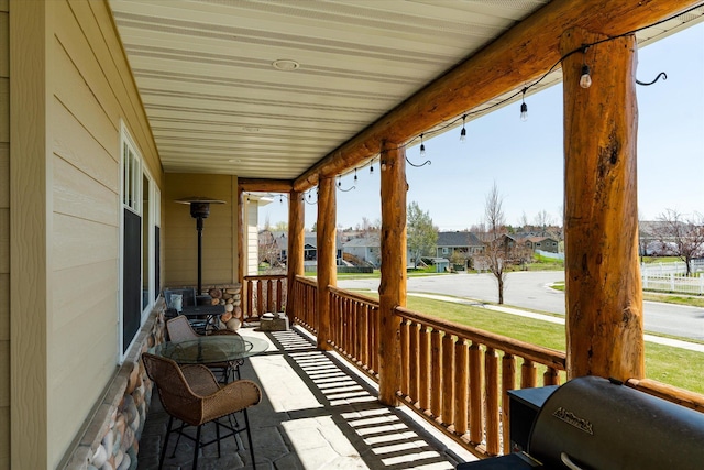 wooden terrace with a residential view and a porch