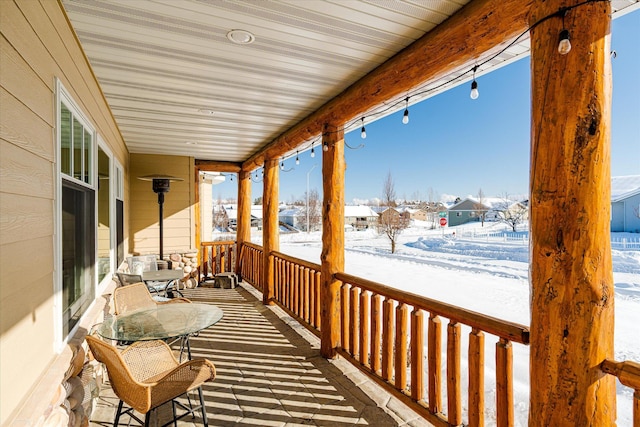 view of snow covered back of property