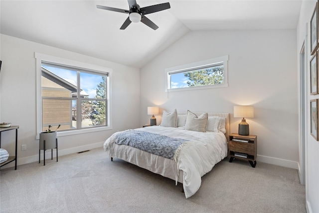 bedroom featuring light colored carpet, vaulted ceiling, baseboards, and a ceiling fan