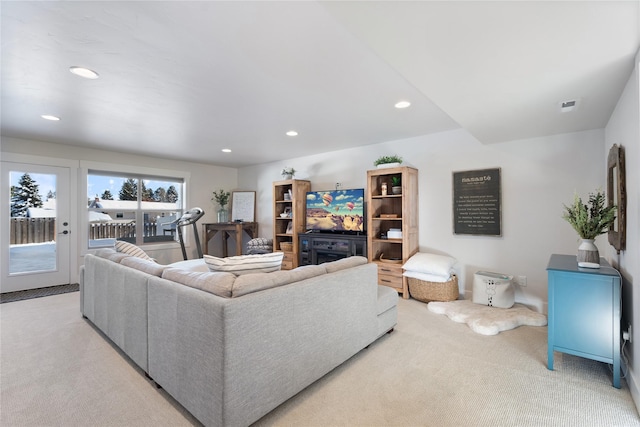 living room featuring light colored carpet, visible vents, and recessed lighting